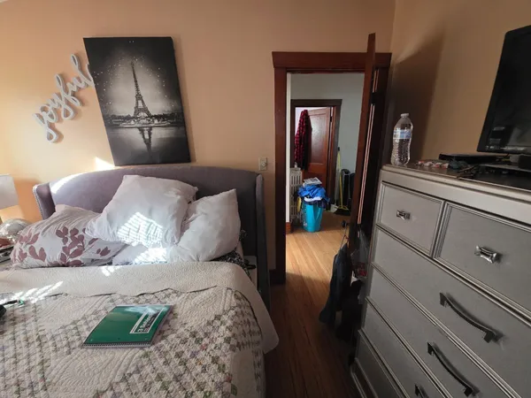 a bed room with a bed and a television