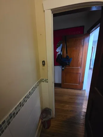 a view of hallway with wooden floor