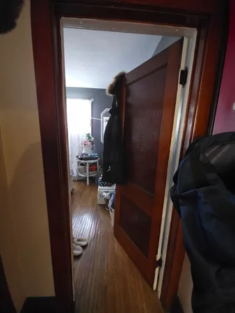 a view of entryway and hall with wooden floor