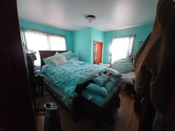 a bedroom with a bed and a mirror