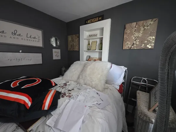 a bedroom with a bed and a television