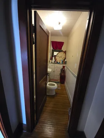 a bathroom with a toilet sink and mirror