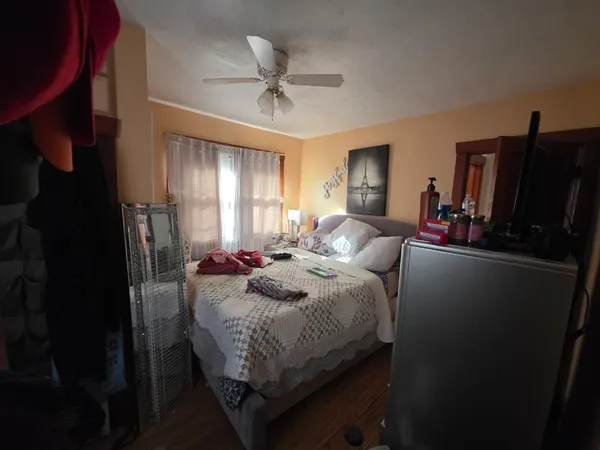 a bedroom with bed and window