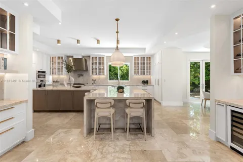 a kitchen with kitchen island granite countertop a sink counter top space and living room view