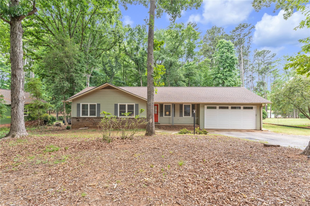 4416 Denver Cove Road Anderson, SC 29625 - Photo 3 of 31 A classic ranch home nestled among mature trees offers serene living with an attached garage.