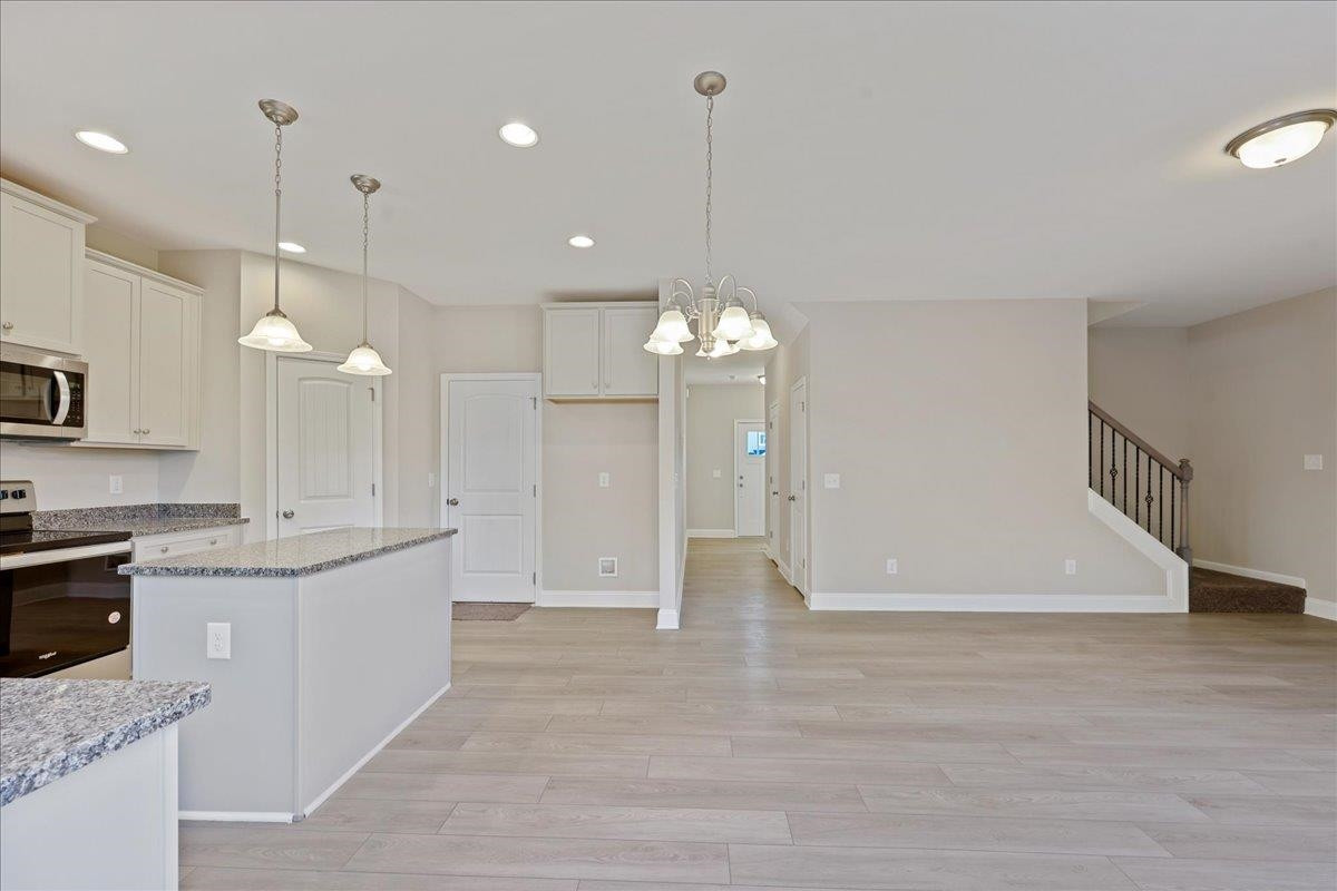 2178 Campbell Loop Burlington, NC 27215 - Photo 12 of 30 a large kitchen with granite countertop a stove a sink a refrigerator and a fireplace