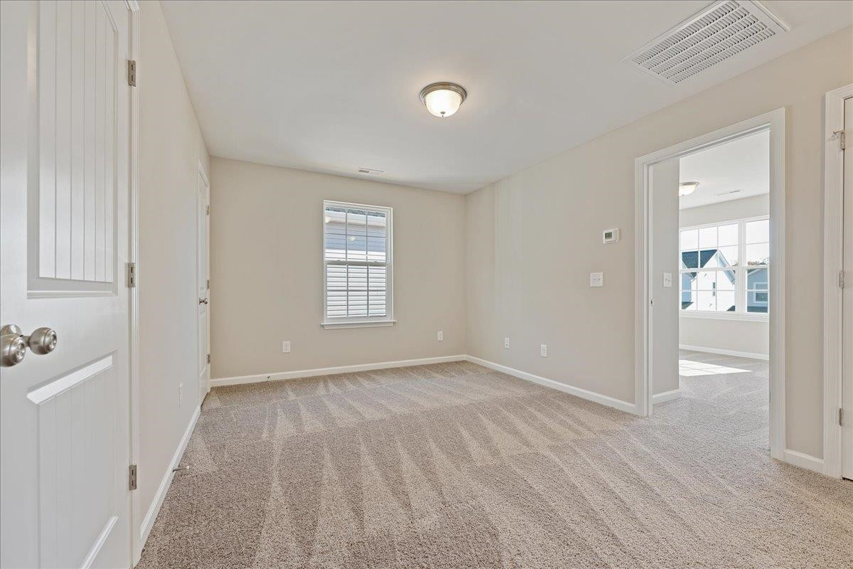 2178 Campbell Loop Burlington, NC 27215 - Photo 18 of 30 wooden floor in an empty room with a window