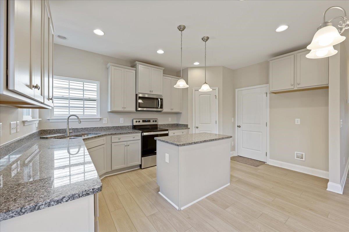 2178 Campbell Loop Burlington, NC 27215 - Photo 10 of 30 a kitchen with granite countertop white cabinets and white appliances