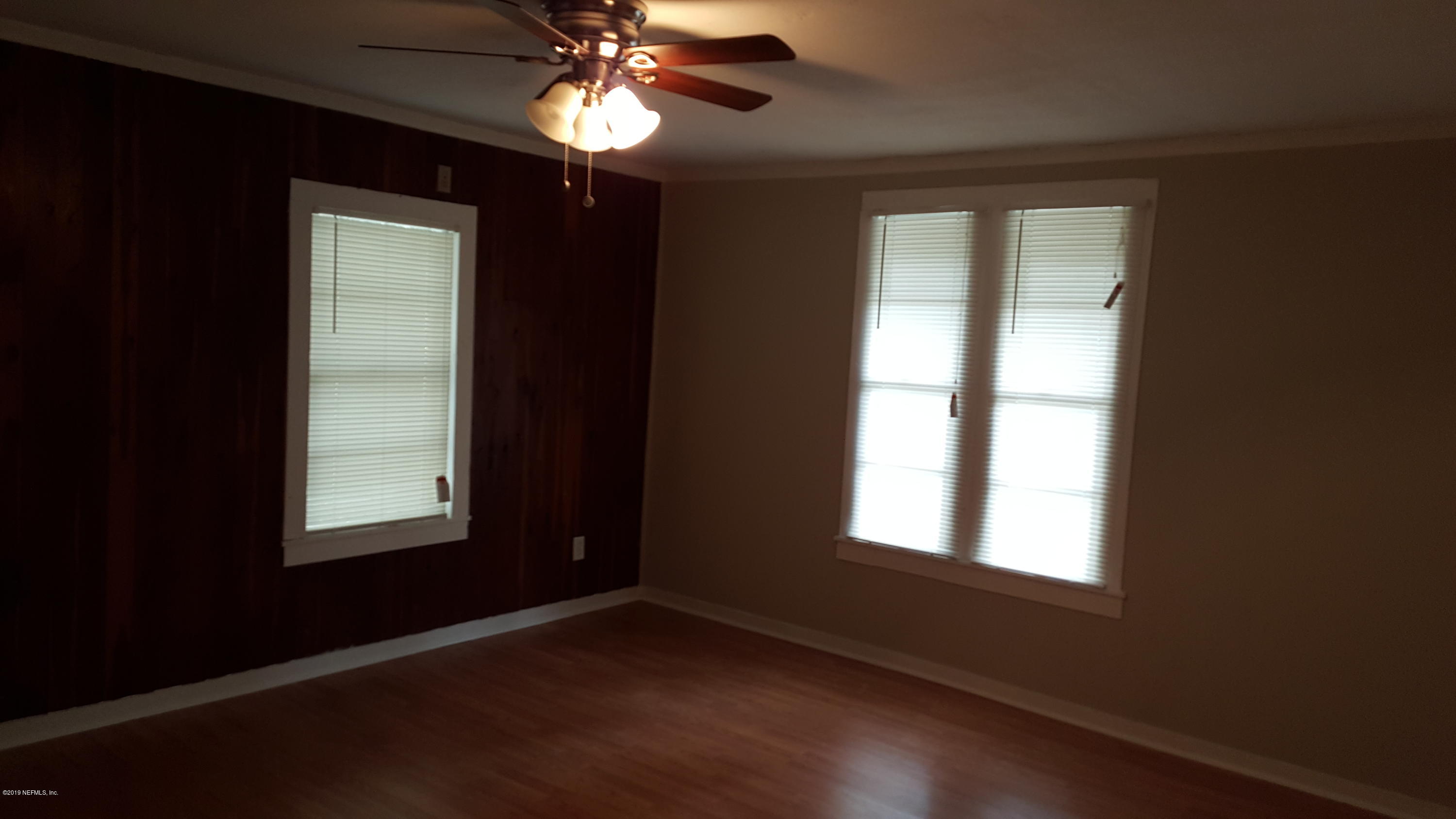 5303 Burdette Road Jacksonville, FL 32211 - Photo 7 of 14 a view of an empty room with a window and wooden floor