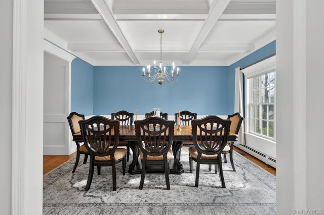 a view of a dining room with furniture and chandelier