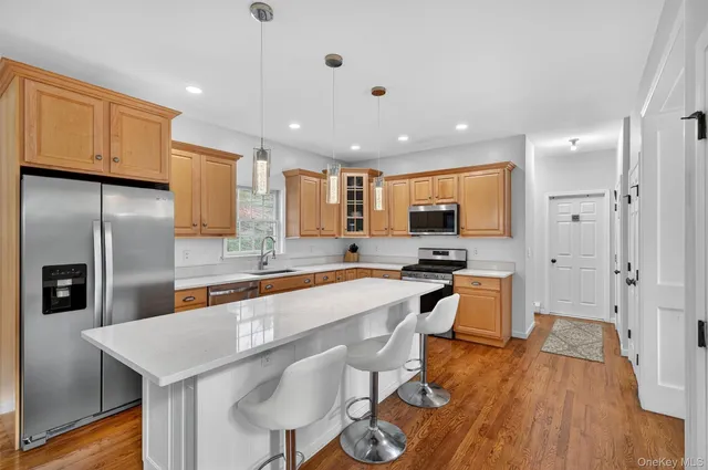 a large kitchen with a large window and stainless steel appliances