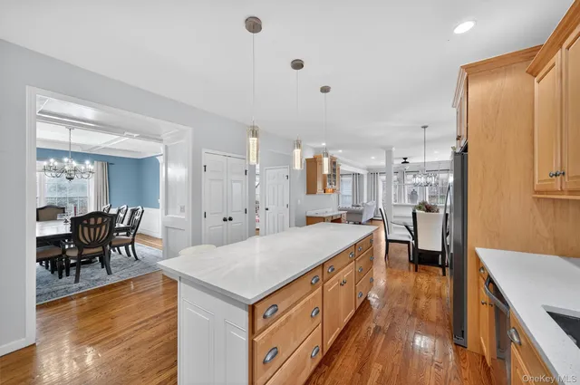 a large white kitchen with a large window and stainless steel appliances