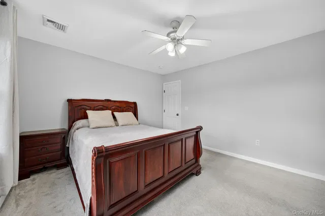 a living room with furniture a window and a gym machine