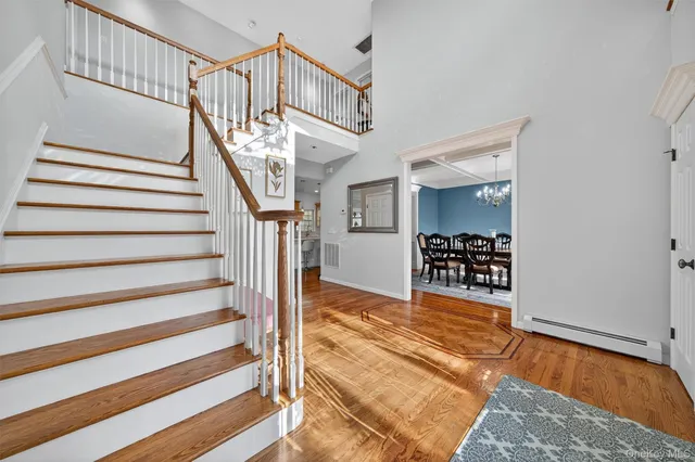 a view of entryway and hall with wooden floor
