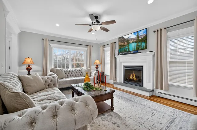 a living room with furniture a window and a fireplace