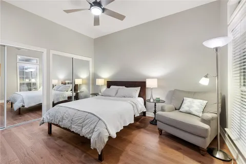 a spacious bedroom with a bed and a chandelier