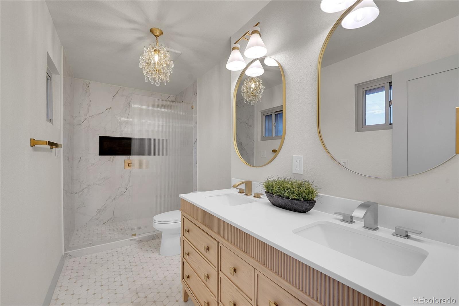 830 Welch Street Golden, CO 80401 - Photo 17 of 37 a bathroom with a sink a toilet and a mirror