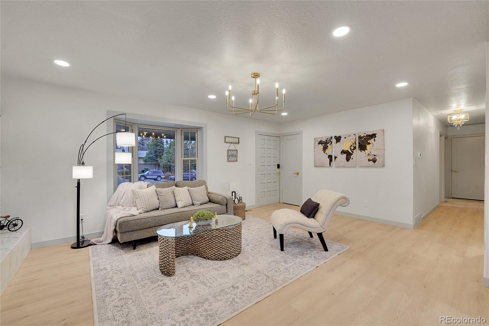 830 Welch Street Golden, CO 80401 - Photo 2 of 37 a living room with furniture and a chandelier