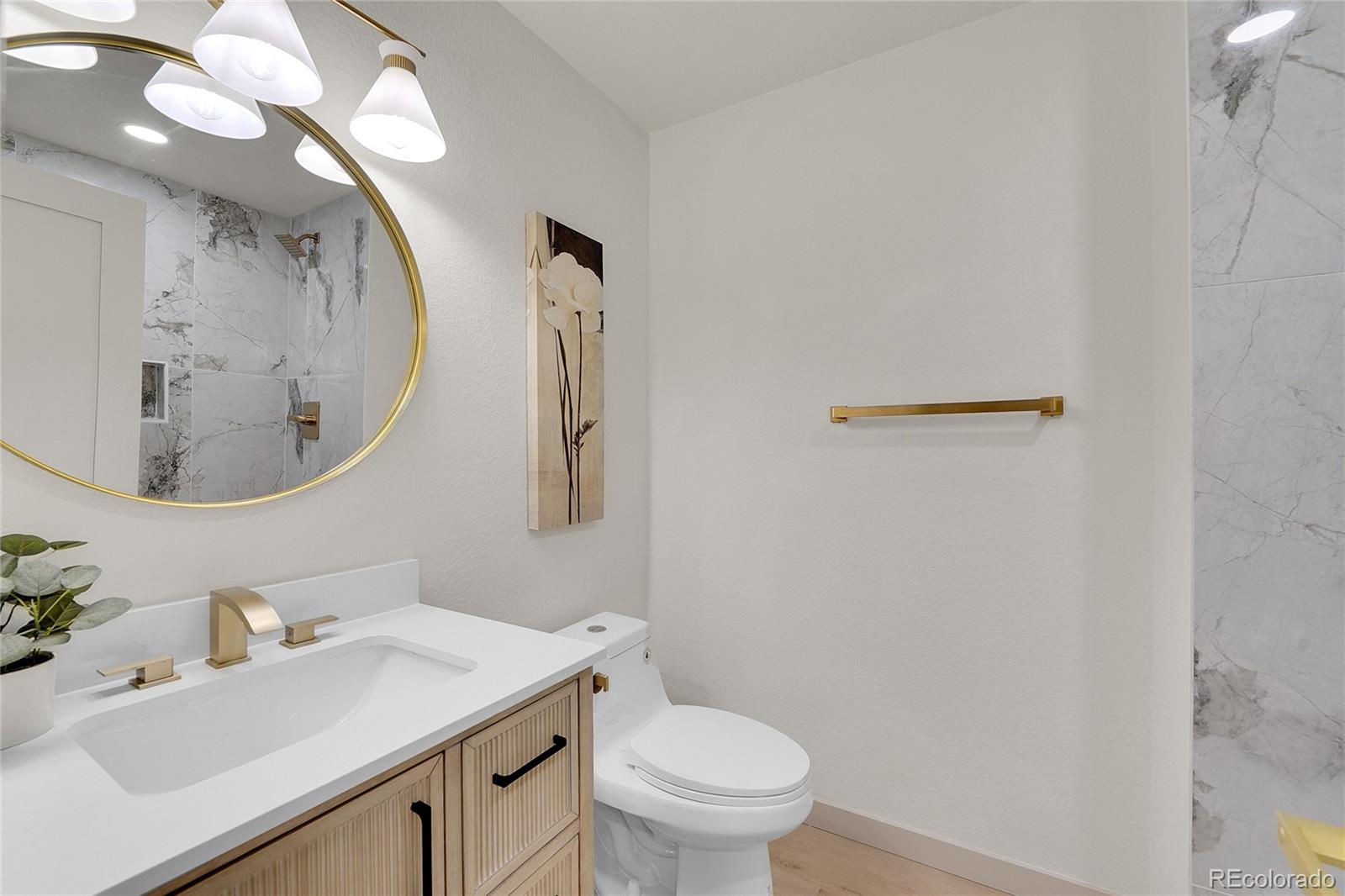 830 Welch Street Golden, CO 80401 - Photo 21 of 37 a bathroom with a sink vanity mirror and toilet