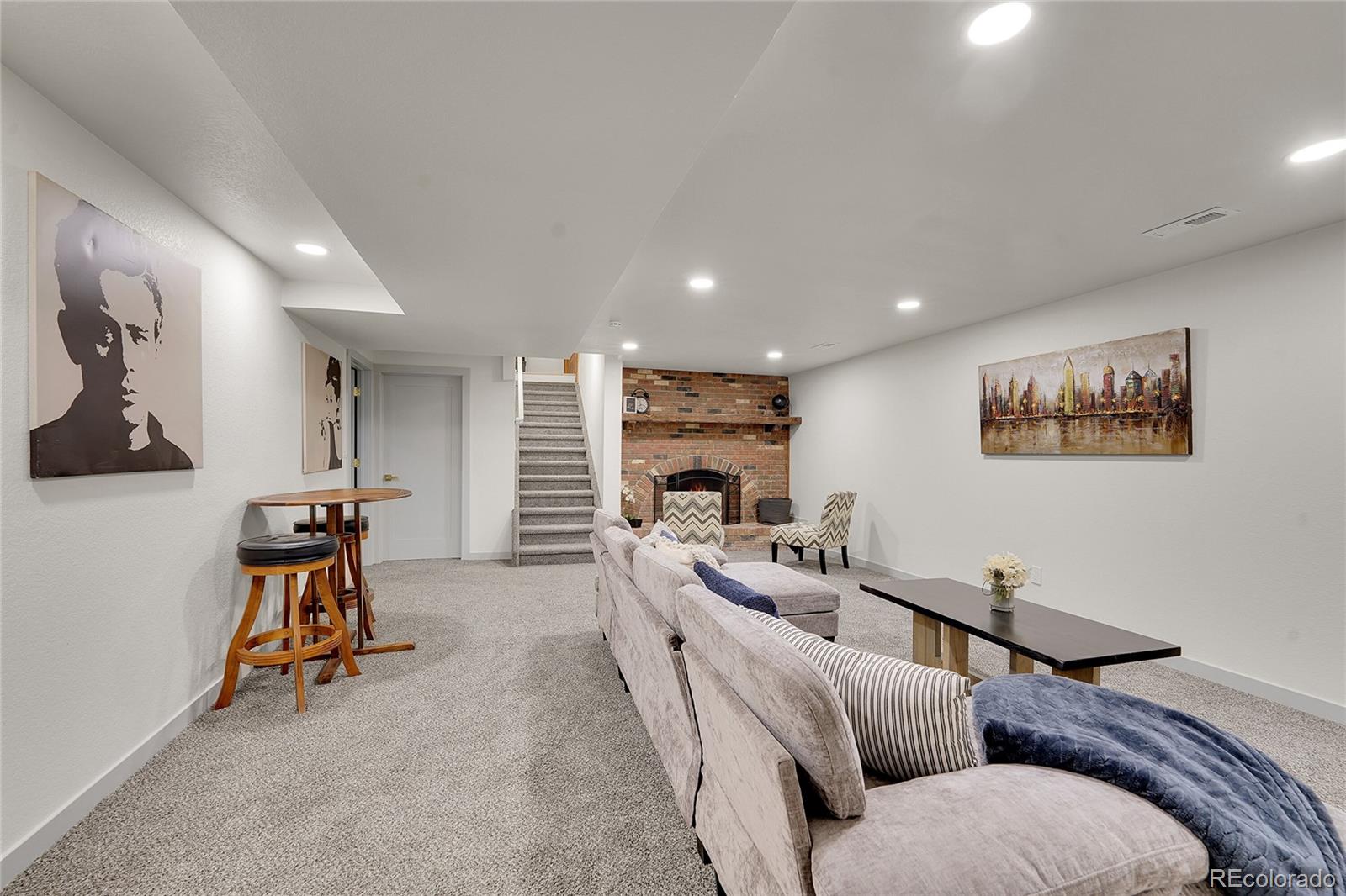 830 Welch Street Golden, CO 80401 - Photo 25 of 37 a living room with furniture gym equipment and a flat screen tv