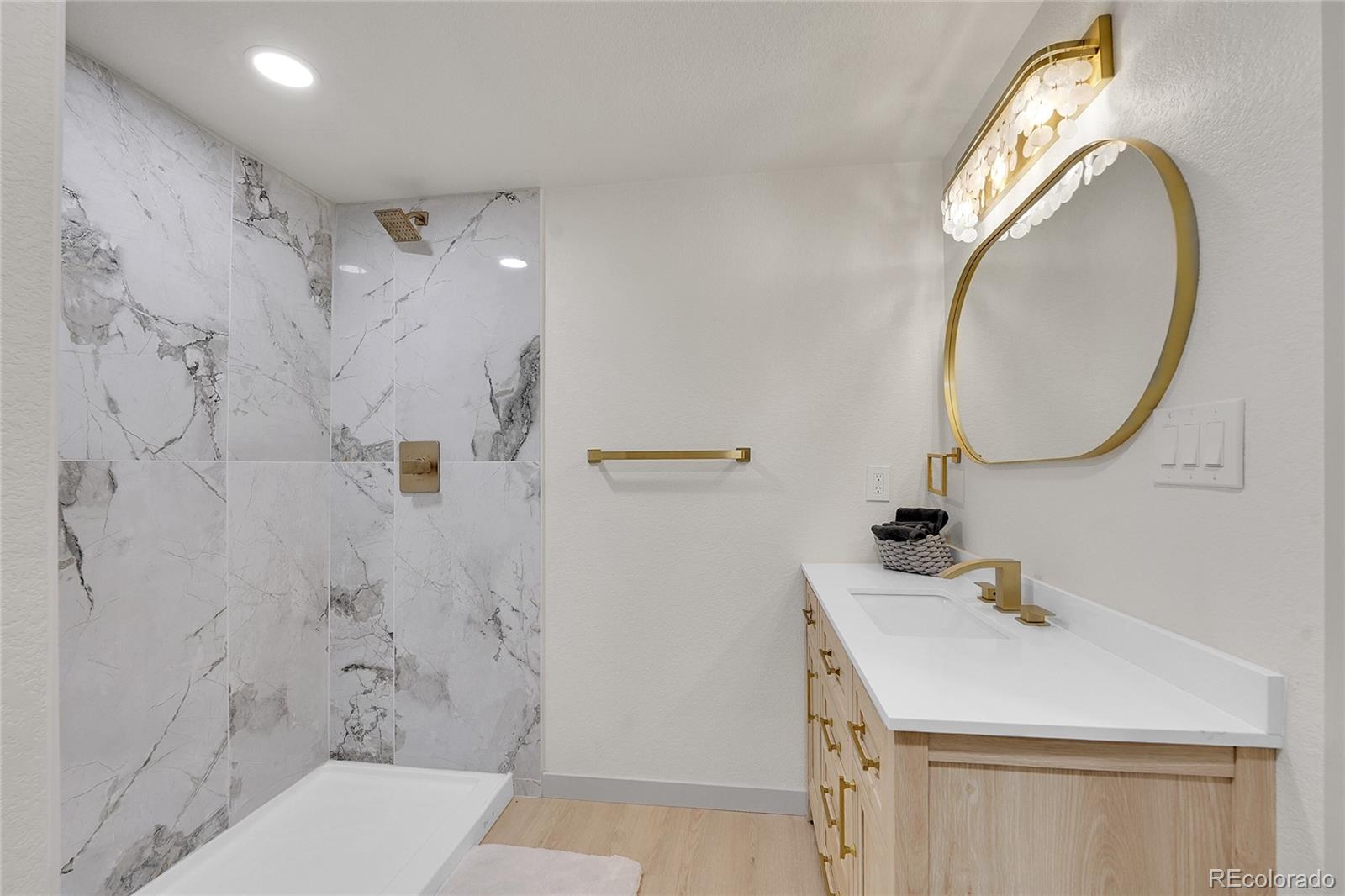 830 Welch Street Golden, CO 80401 - Photo 32 of 37 a bathroom with a sink a toilet and a mirror