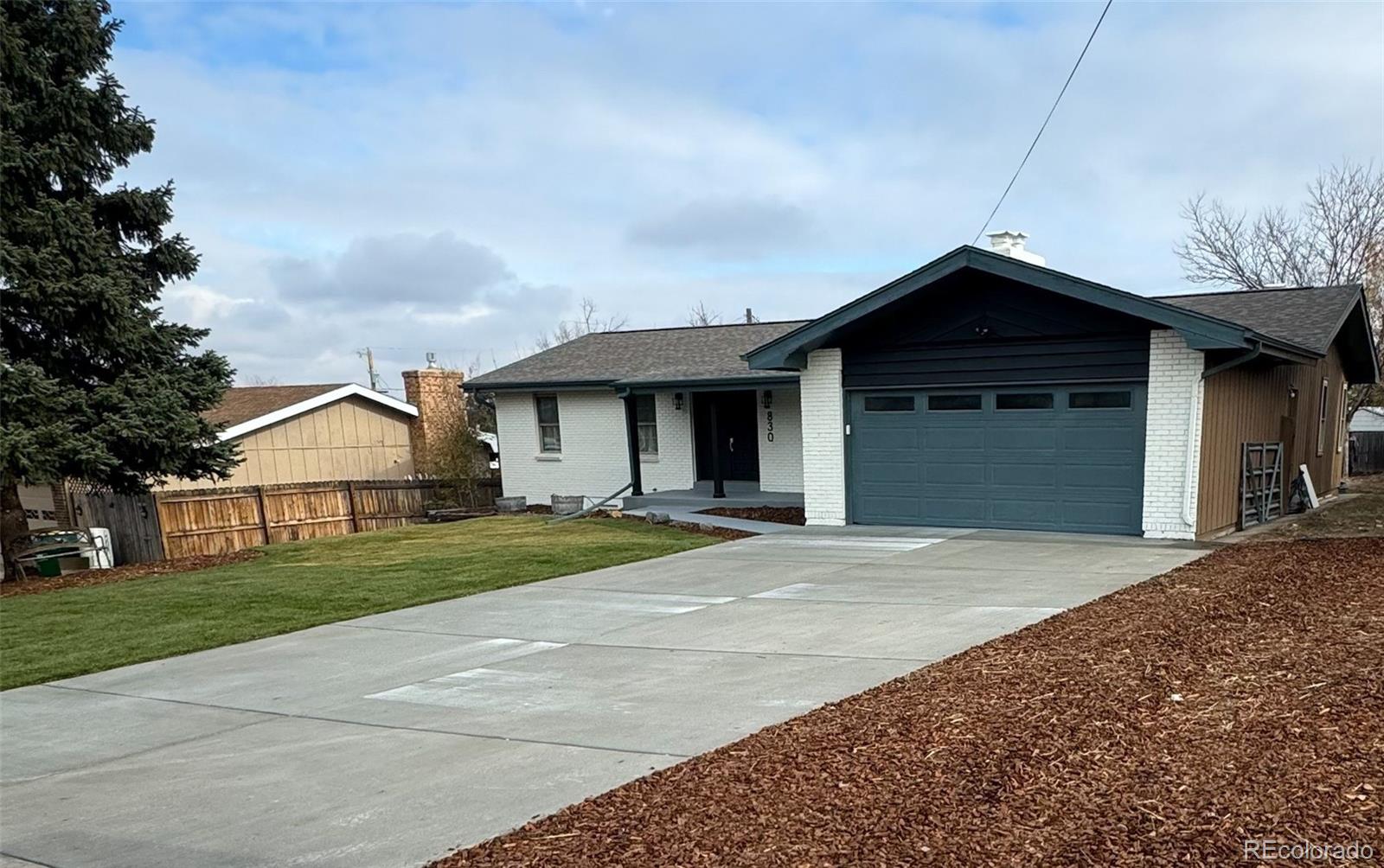 830 Welch Street Golden, CO 80401 - Photo 34 of 37 a front view of a house with a yard and garage