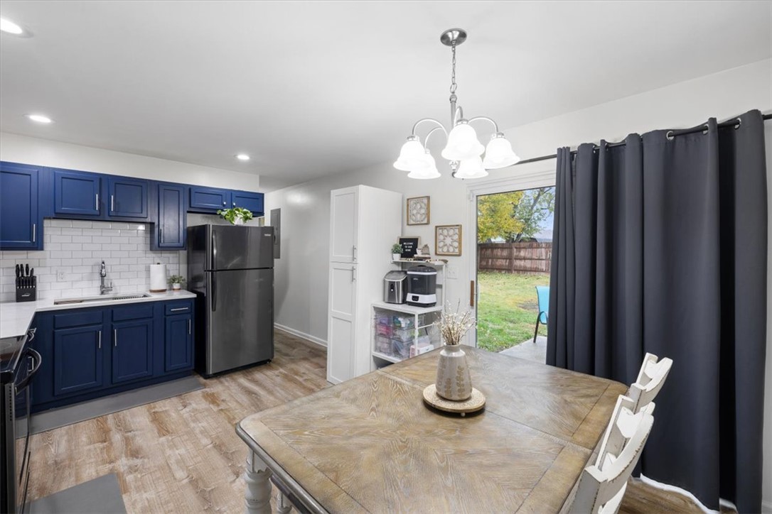 1482 Lee Road Troy, OH 45373 - Photo 18 of 30 This inviting kitchen and dining area offers direct backyard access, ideal for seamless indoor-outdoor living.
