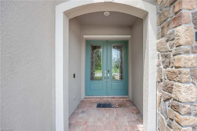 a view of a hallway to a livingroom with windows