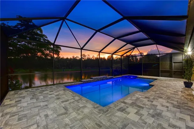 a view of a backyard of a house with swimming pool