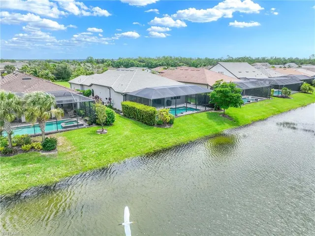 an aerial view of a house with garden space and swimming pool