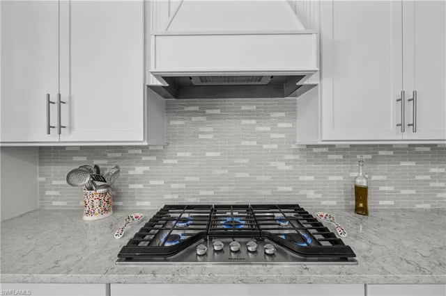 a kitchen with granite countertop a stove and a sink