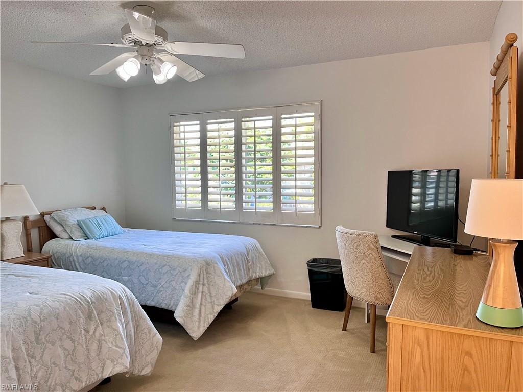 232 Memory Lane, Unit 4 Naples, FL 34112 - Photo 12 of 33 a bedroom with two bed and a desk