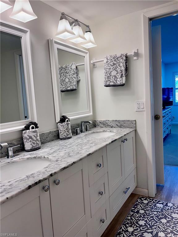 232 Memory Lane, Unit 4 Naples, FL 34112 - Photo 16 of 33 a bathroom with a granite countertop sink and a mirror