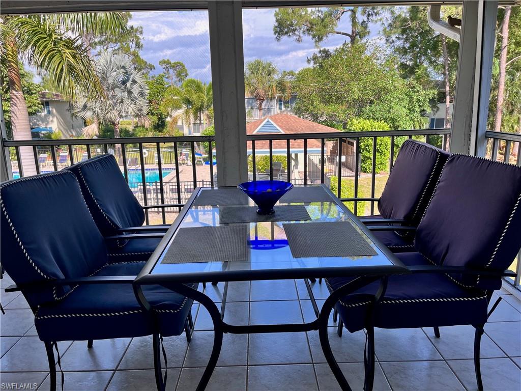 232 Memory Lane, Unit 4 Naples, FL 34112 - Photo 19 of 33 a view of a workspace with furniture window and wooden floor