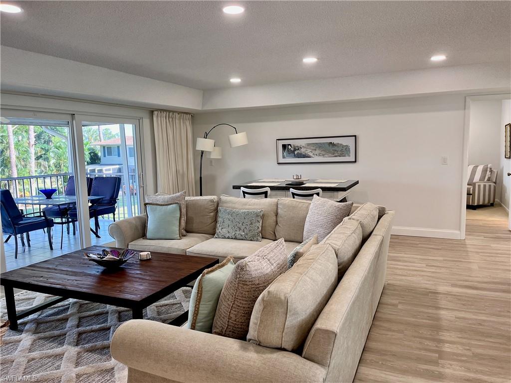 232 Memory Lane, Unit 4 Naples, FL 34112 - Photo 2 of 33 a living room with furniture and wooden floor