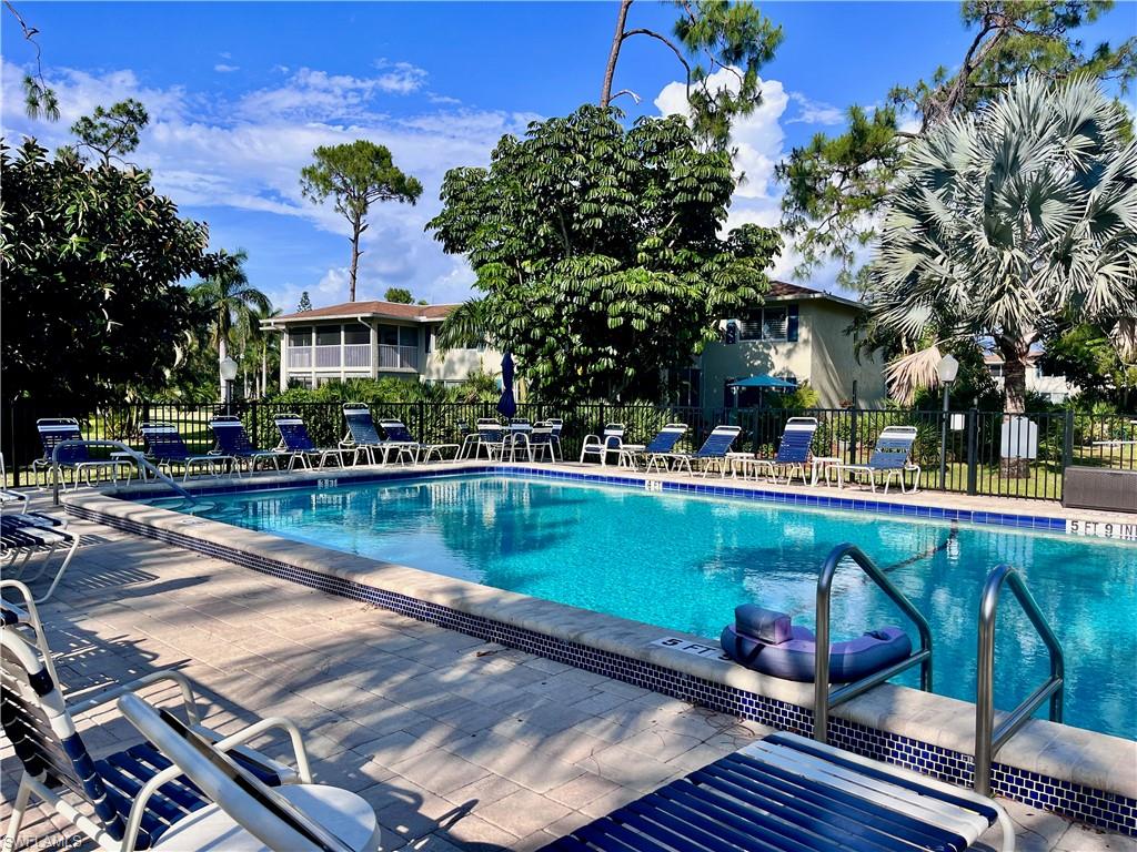 232 Memory Lane, Unit 4 Naples, FL 34112 - Photo 23 of 33 a view of a swimming pool with outdoor seating