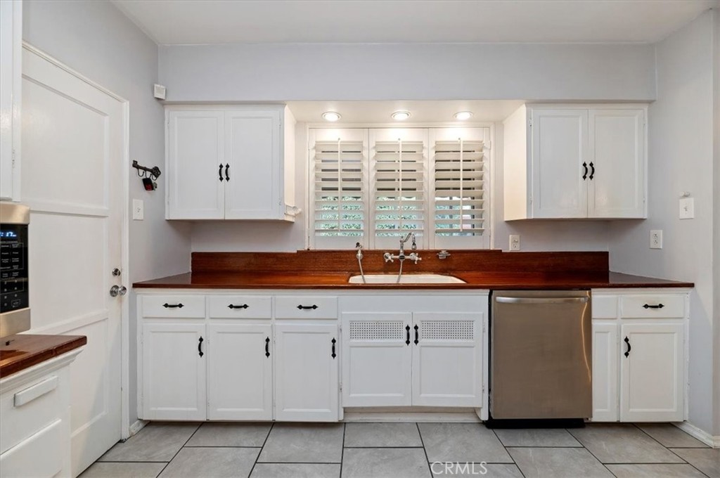 3630 Castle Reagh Place Riverside, CA 92506 - Photo 14 of 37 a kitchen with white cabinets and sink