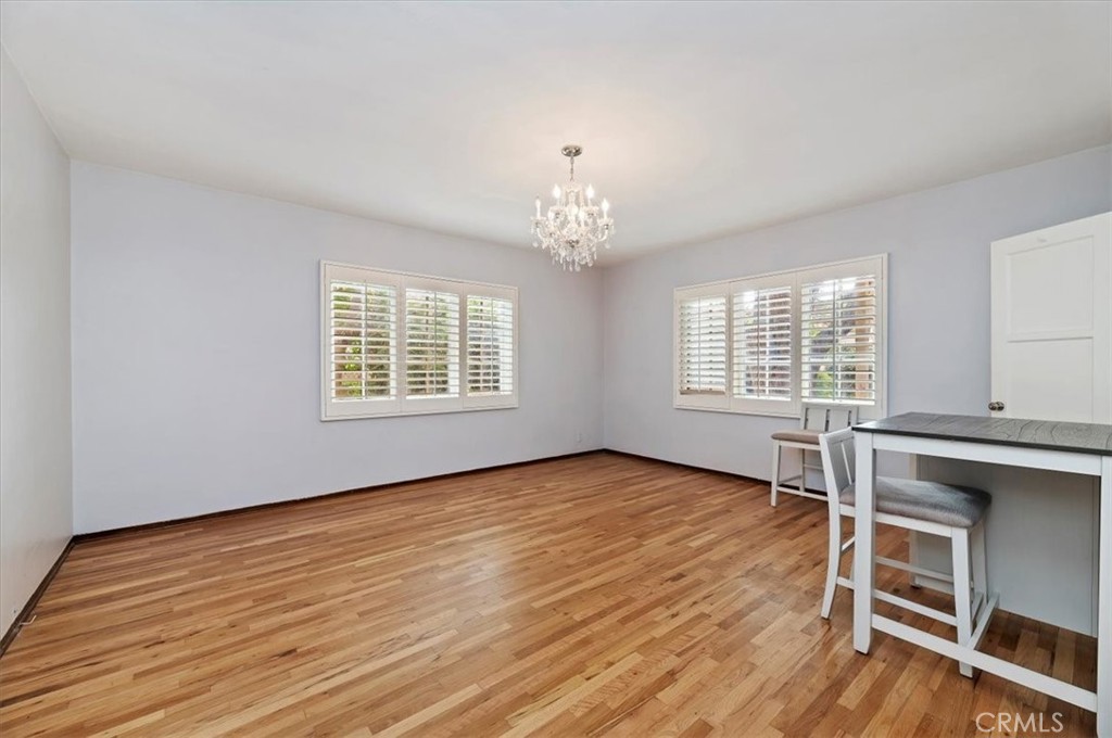 3630 Castle Reagh Place Riverside, CA 92506 - Photo 20 of 37 an empty room with wooden floor exposed radiator and windows