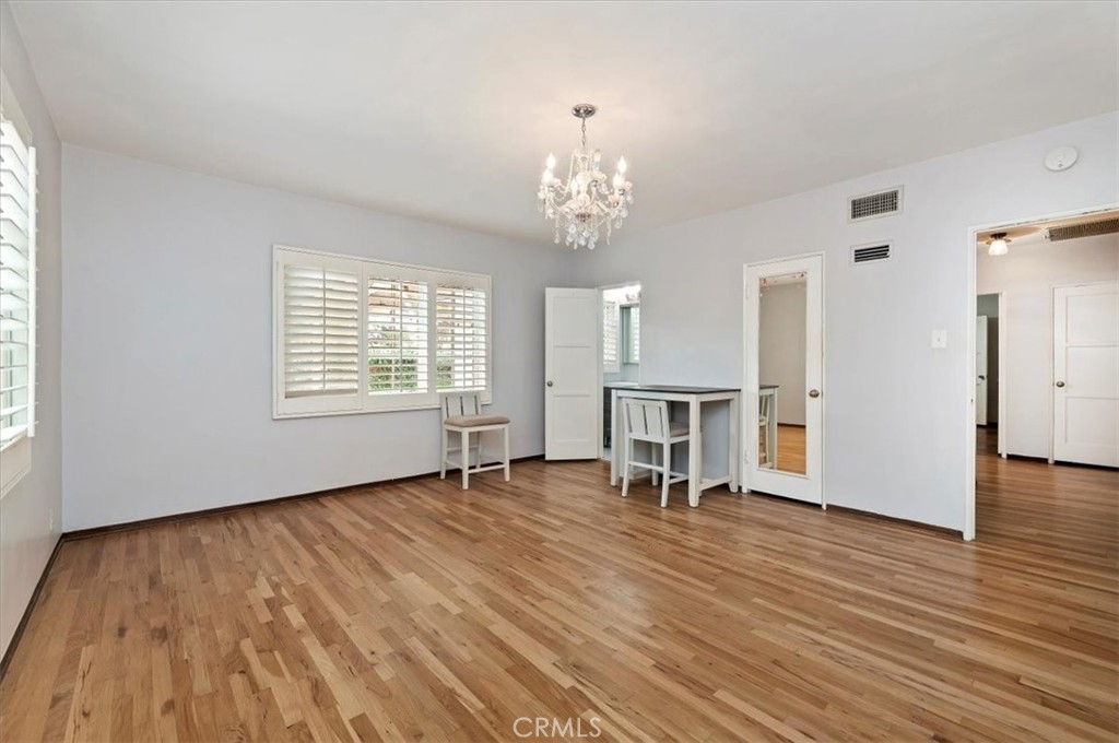 3630 Castle Reagh Place Riverside, CA 92506 - Photo 21 of 37 an empty room with wooden floor a fireplace and windows
