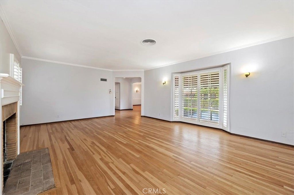 3630 Castle Reagh Place Riverside, CA 92506 - Photo 5 of 37 a view of an empty room with wooden floor and a window
