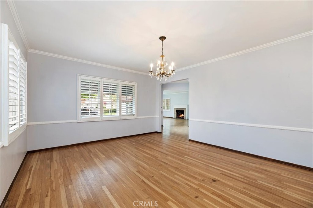 3630 Castle Reagh Place Riverside, CA 92506 - Photo 6 of 37 an empty room with wooden floor chandelier and windows
