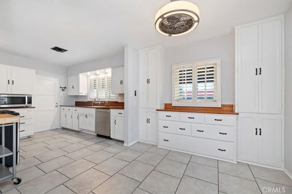 3630 Castle Reagh Place Riverside, CA 92506 - Photo 7 of 37 a kitchen with a cabinets and chandelier