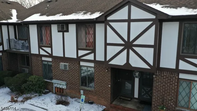 a front view of a house with porch and wooden stairs