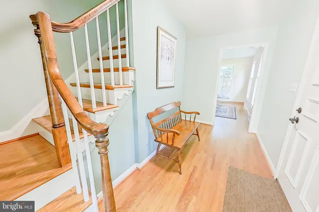 a view of an entryway with wooden floor and door