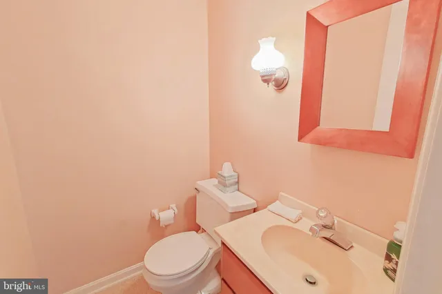 a white toilet sitting next to a bathroom sink