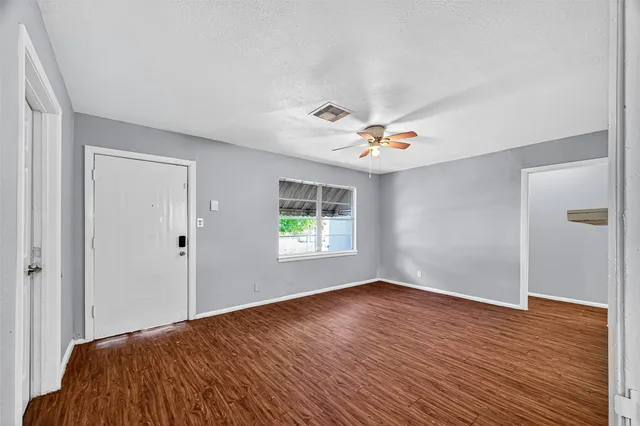 a view of a livingroom with wooden floor and window