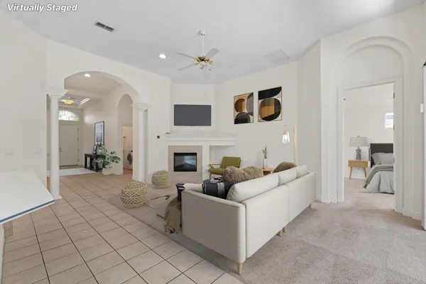 a living room with furniture and a fireplace