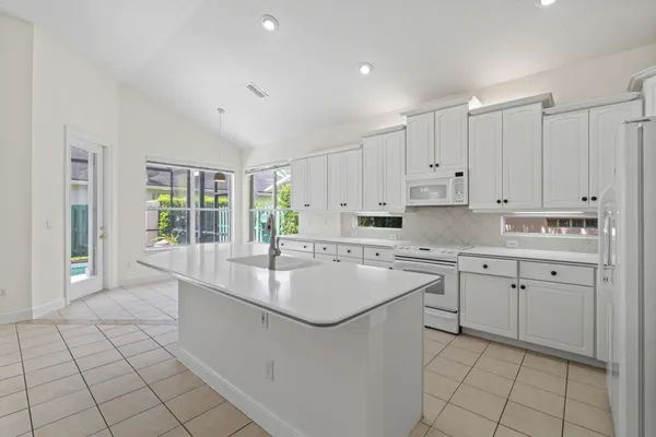 a kitchen that has a sink and a stove in it
