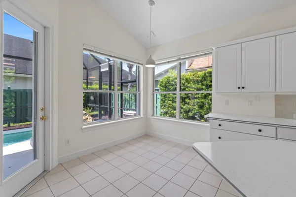 a bedroom with bed and a large window