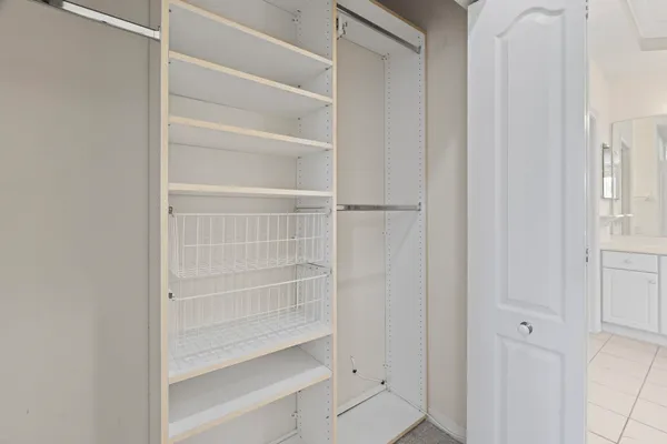 a view of walk in closet with empty racks